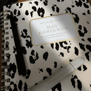 image of leopard planner with black pen and rhode gloss